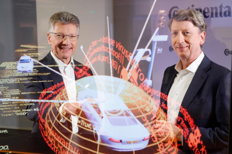 Continental CEO Dr. Elmar Degenhart and CFO Wolfgang Schäfer show the digital protection shield of a car. 