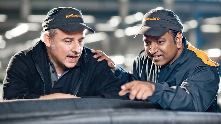 A Continental employee shows his colleague a product.