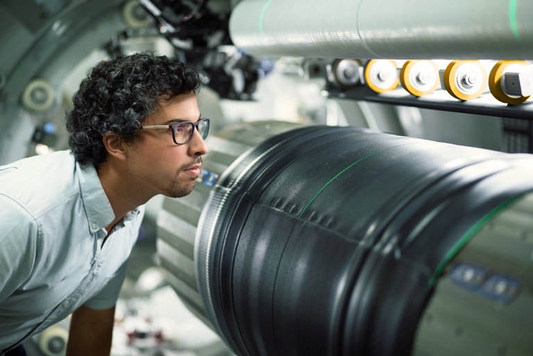 An expert checking the tire manufacturing process