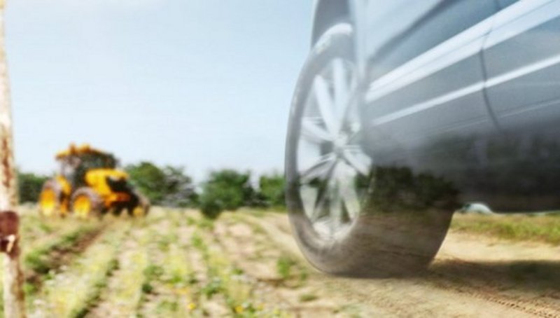 A composition of two hands scraping milk out of a jar, a tractor in a field and a car with a dandelion in front of it